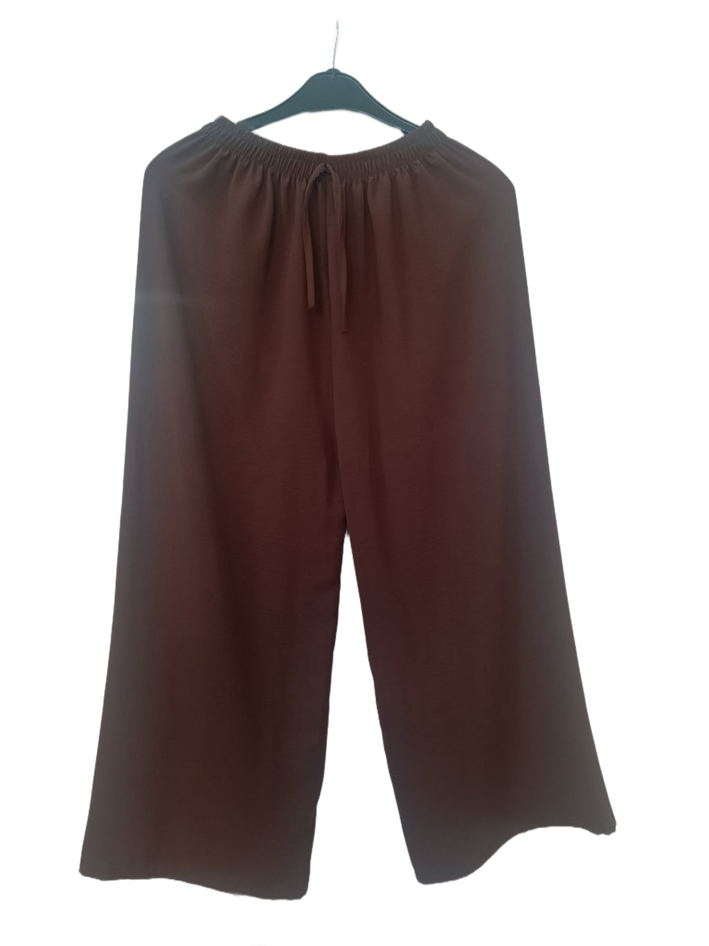 Brown wide-leg pants on a hanger against a white background