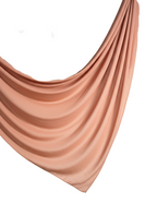 Draped peach fabric on a white background