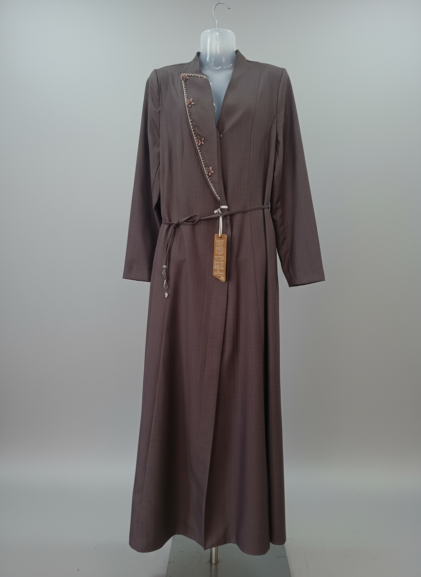 abaya on a mannequin against a plain background