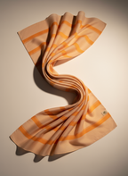 Beige and orange striped fabric on a white background
