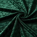 Close-up of dark green textured fabric with a swirl pattern